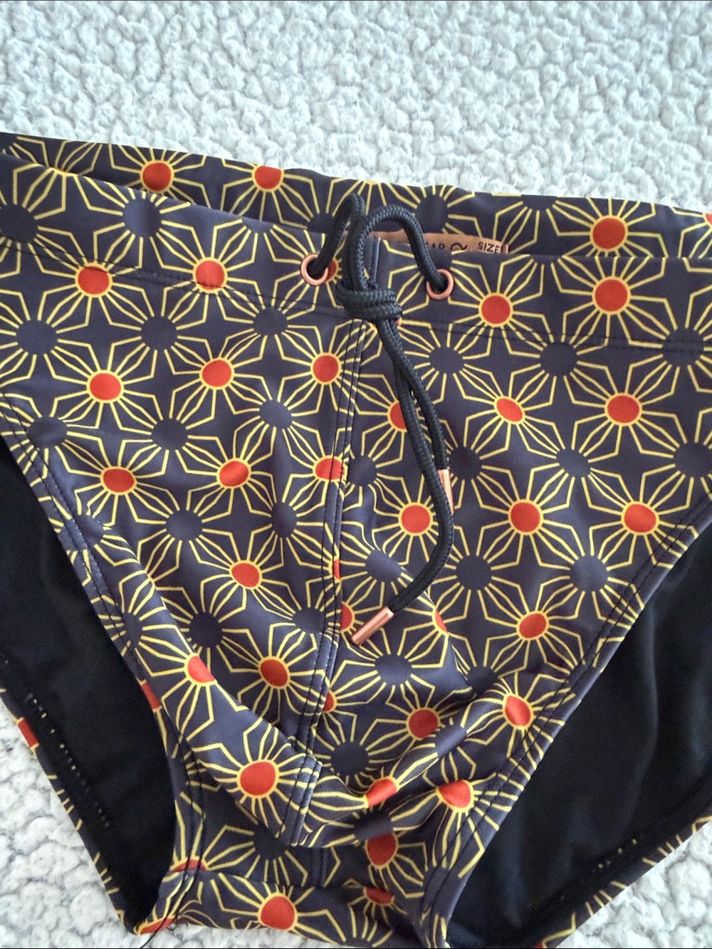 Men's Black Swim Briefs with Orange Starburst Print - Picture 3 of 6